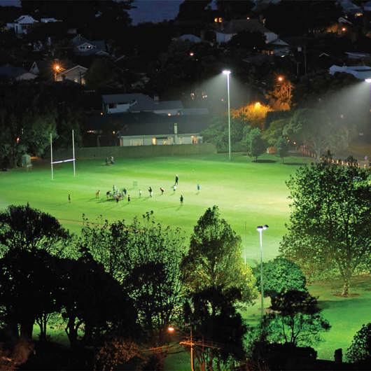 Looking over at a football pitch in the distance at night