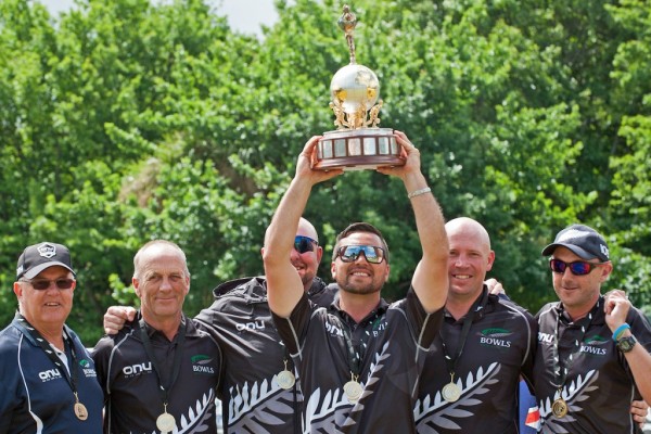 Shannon McIlroy and his team hold up the trophy above the head