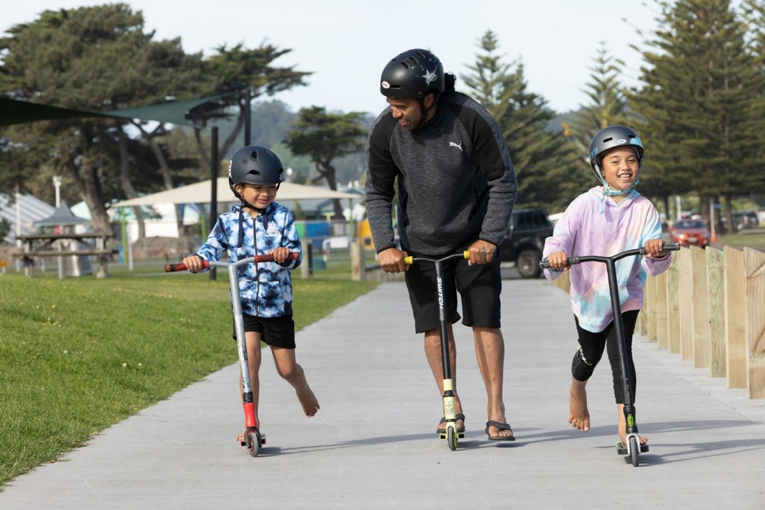 Family riding on scooters