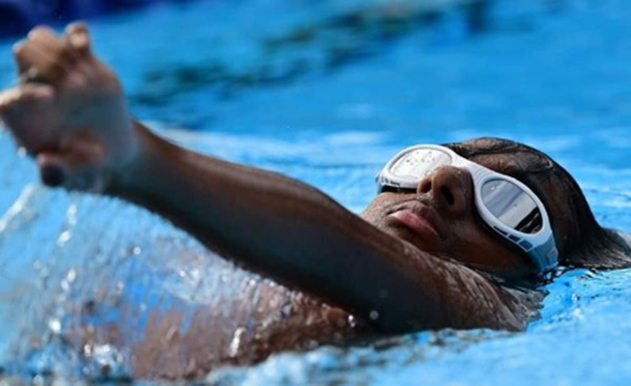 Boy doing backstroke in a pool