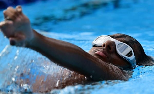 Child doing backstroke in a swimming pool