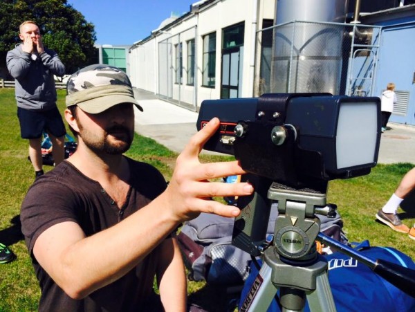 Jamie looking at the speed gun to measure the bowlers speed