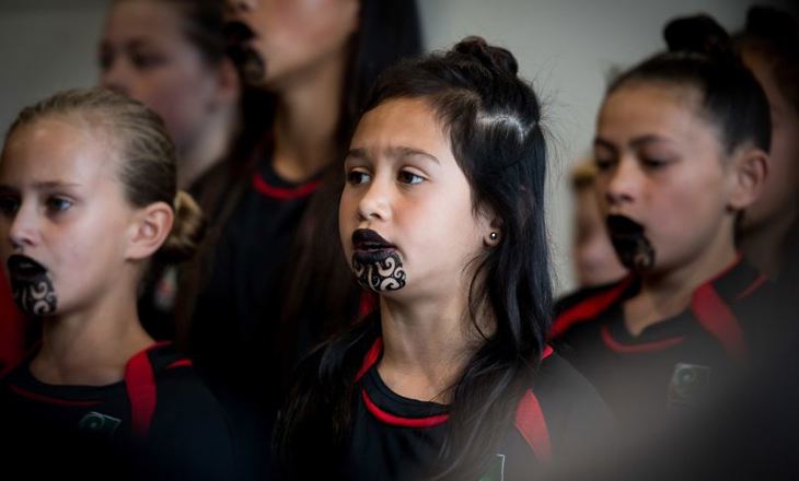 A group of girls with chin tattoos