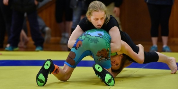 Chanel Kavanagh (in black) wrestles Sam Harrison