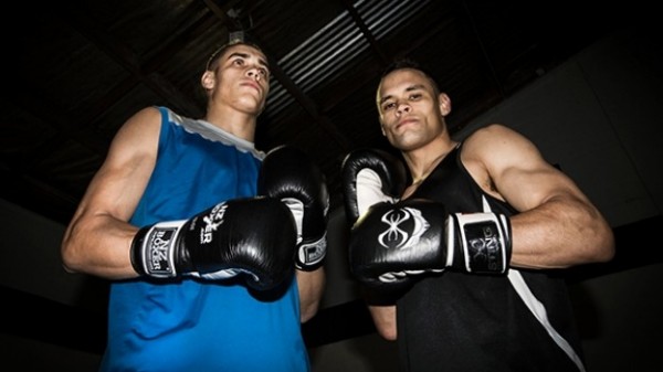 Two boxers, one looking to the right the other looking down to the camera