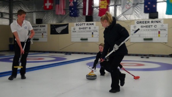 three people doing curling