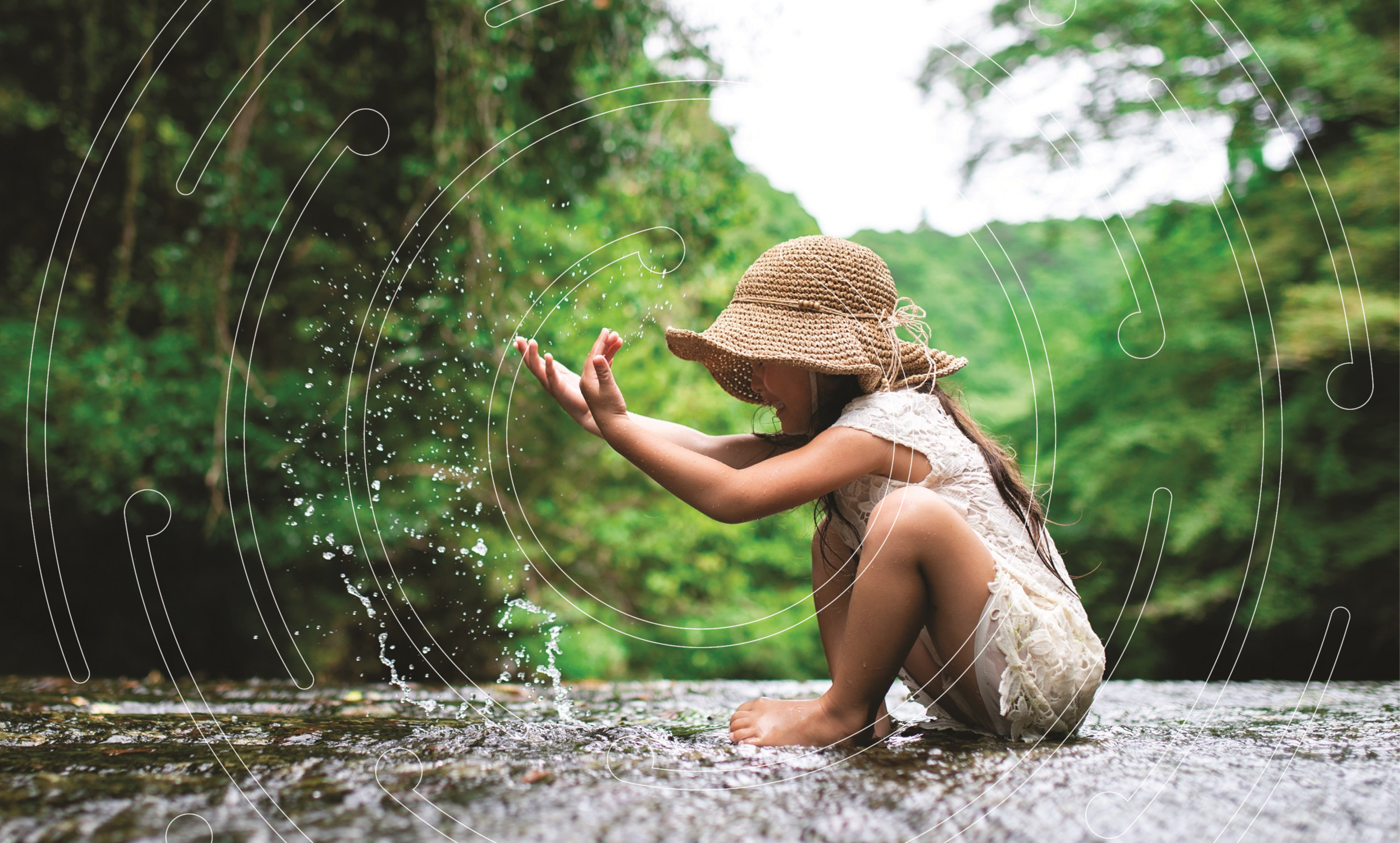 Young girl playing with water in a creek