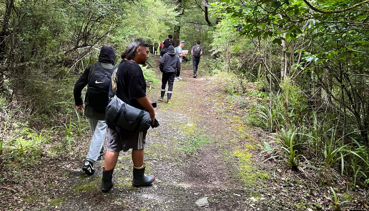 group of kids walking along a bush track