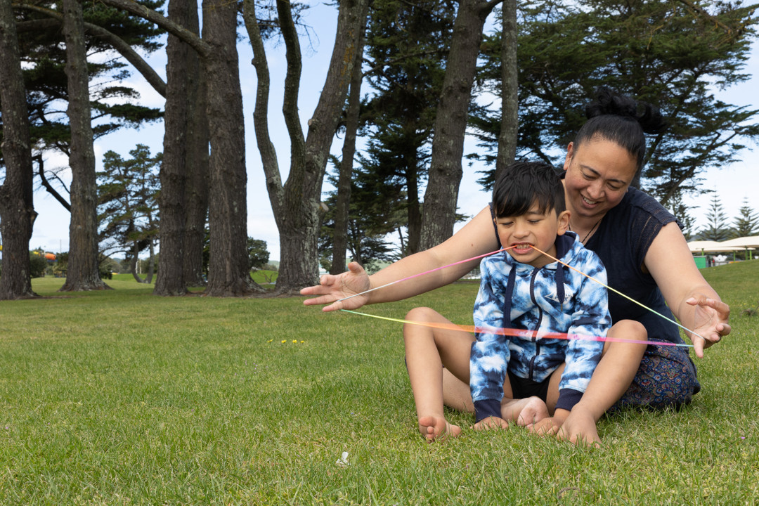 Mother and son playing string games