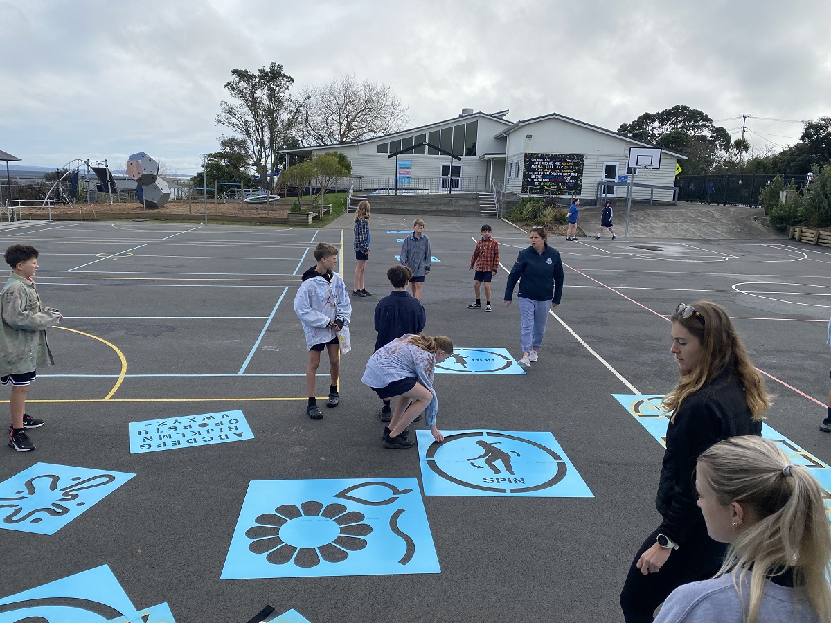 Kids playing outside on a school court