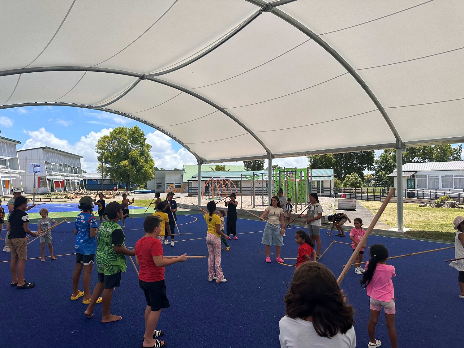 Group of tamariki playing on an indoor turf