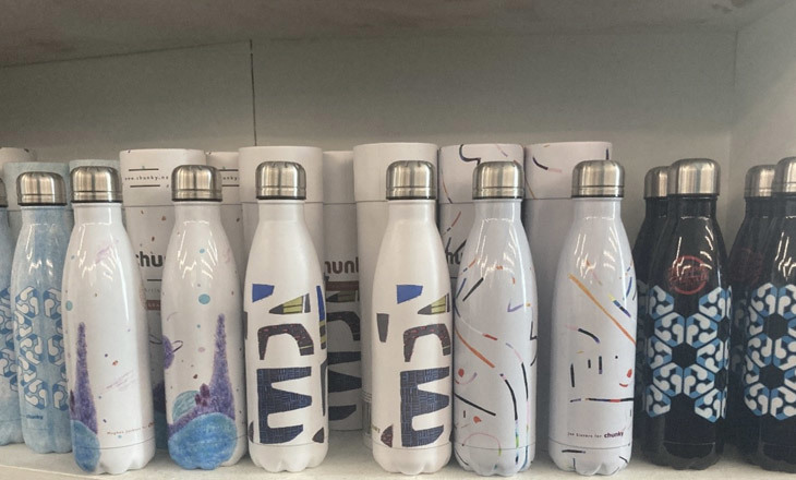 A shelf with lots of drink bottles on it