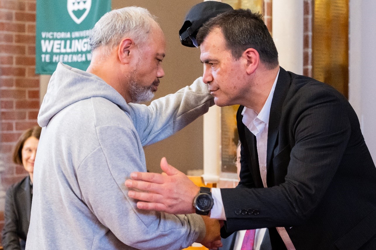 Two men sharing a hongi