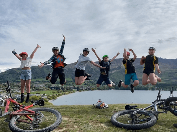 Young women jumping in the air in a row