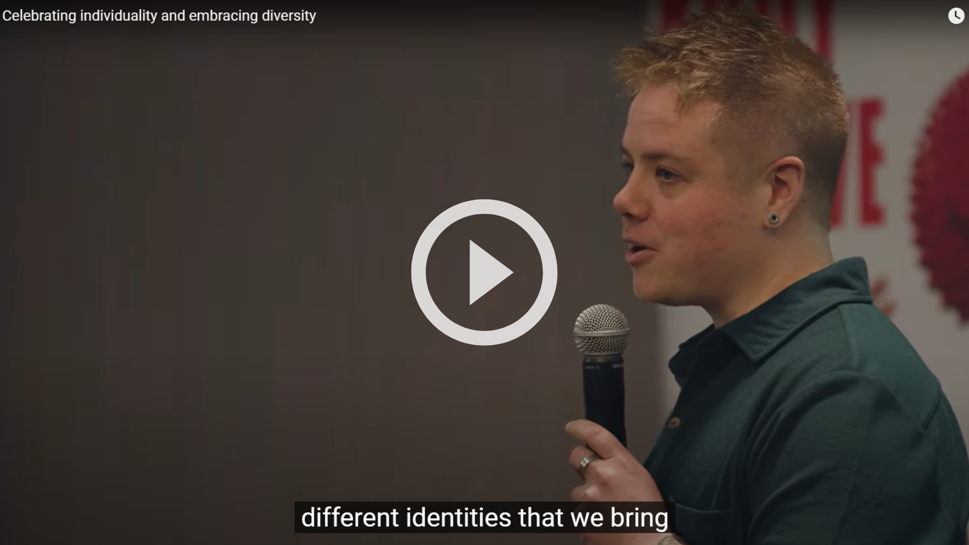 Person holding a microphone talking at a conference