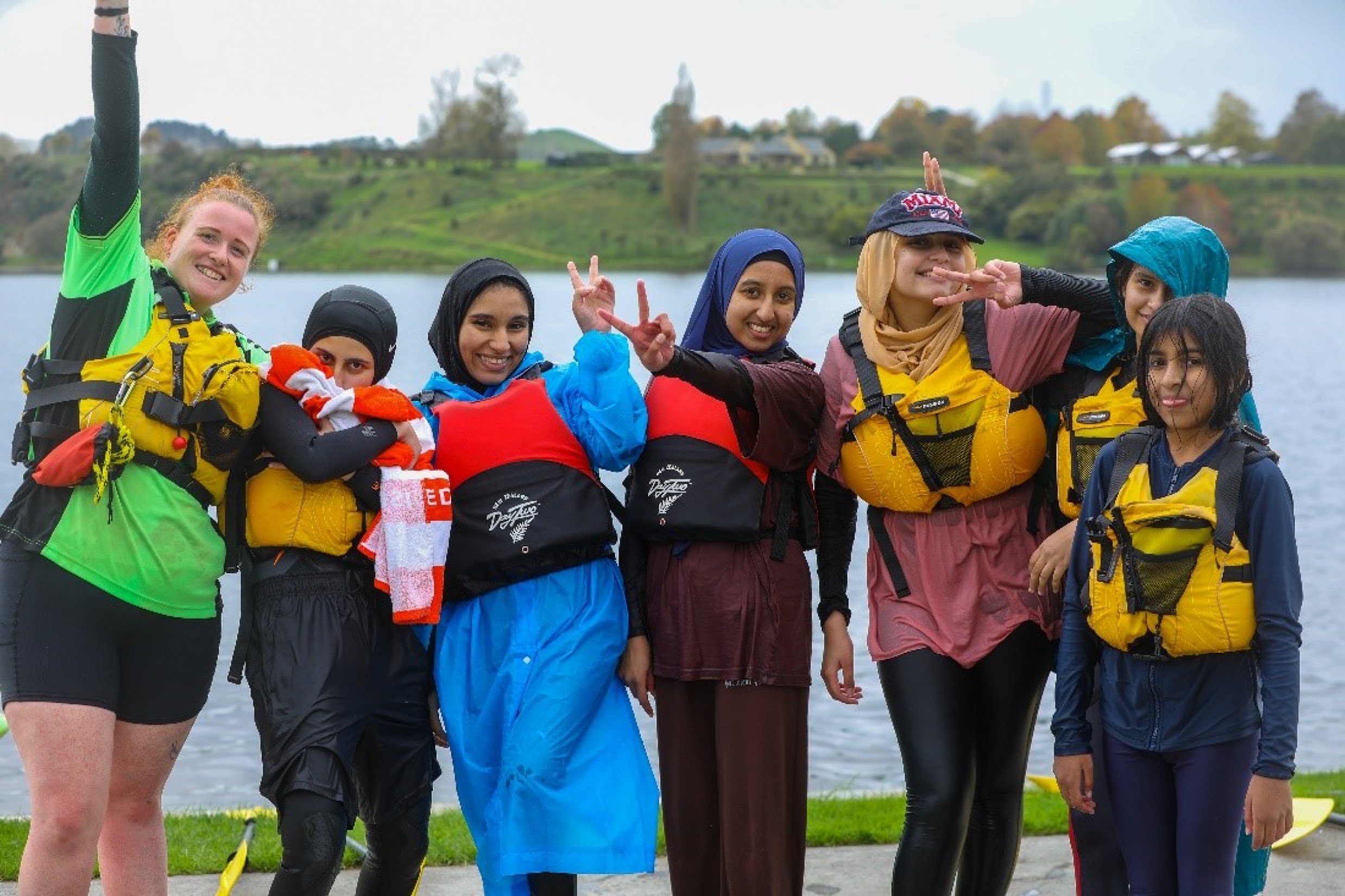 GROUP OF YOUNG WOMEN WAELING LIFE VESTS