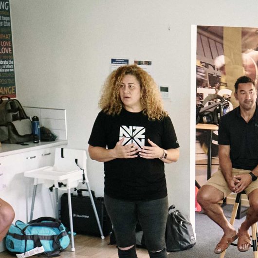 Group of people in a circle listening to a speaker