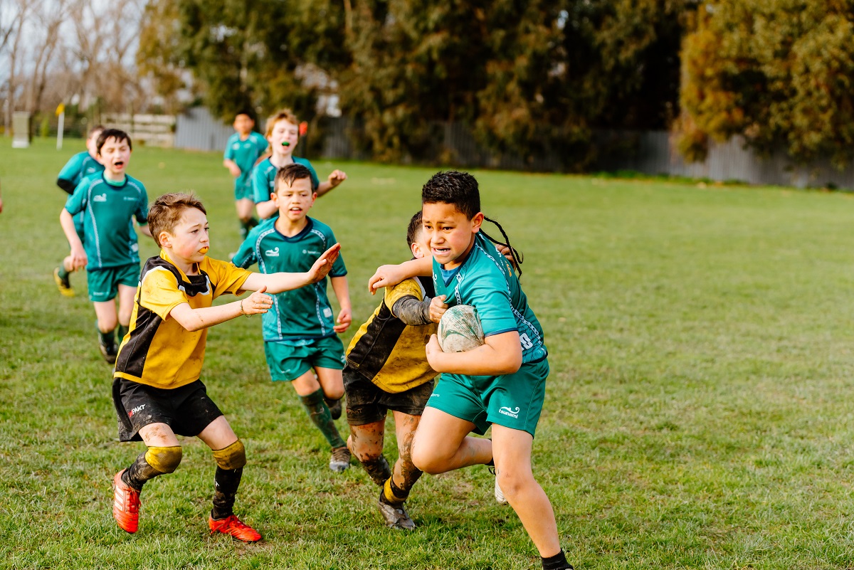 Tamariki playing rugby